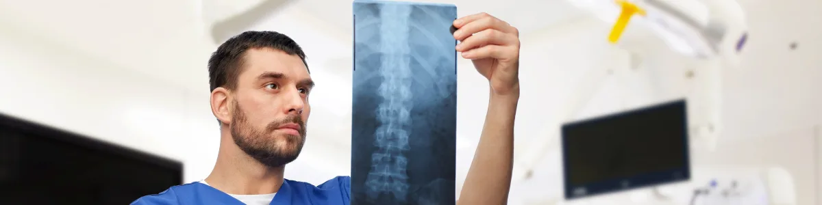 Physician reviewing a spinal X-ray