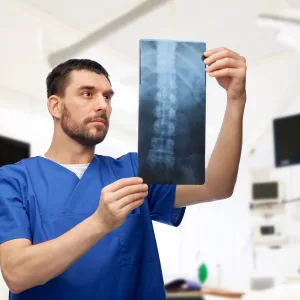 Provider reviewing a spinal X-ray