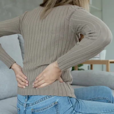 Woman with lower back pain from a herniated disc