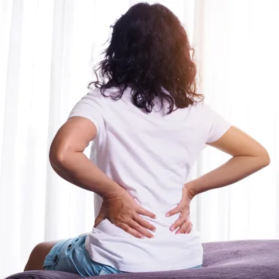 Woman with back pain seeking pain management
