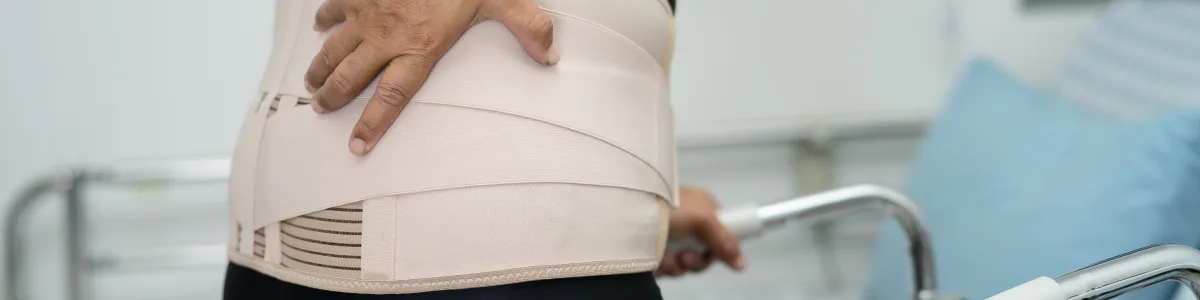 Patient wearing a lumbar back brace