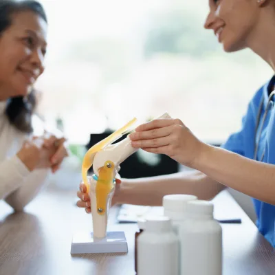 Nurse explaining a spine model to a patient