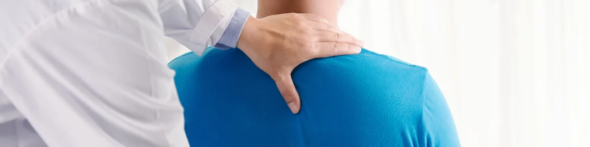 Doctor examining a patient's back